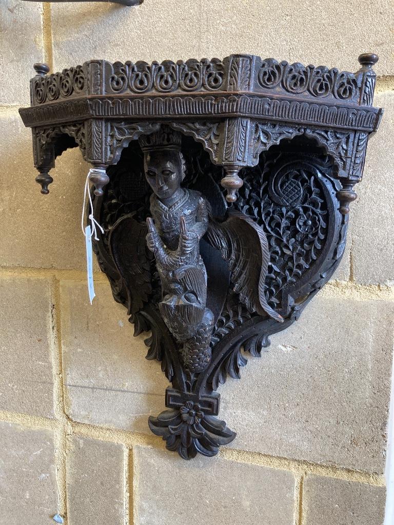 A late 19th century Burmese carved hardwood wall bracket, width 33cm, height 45cm